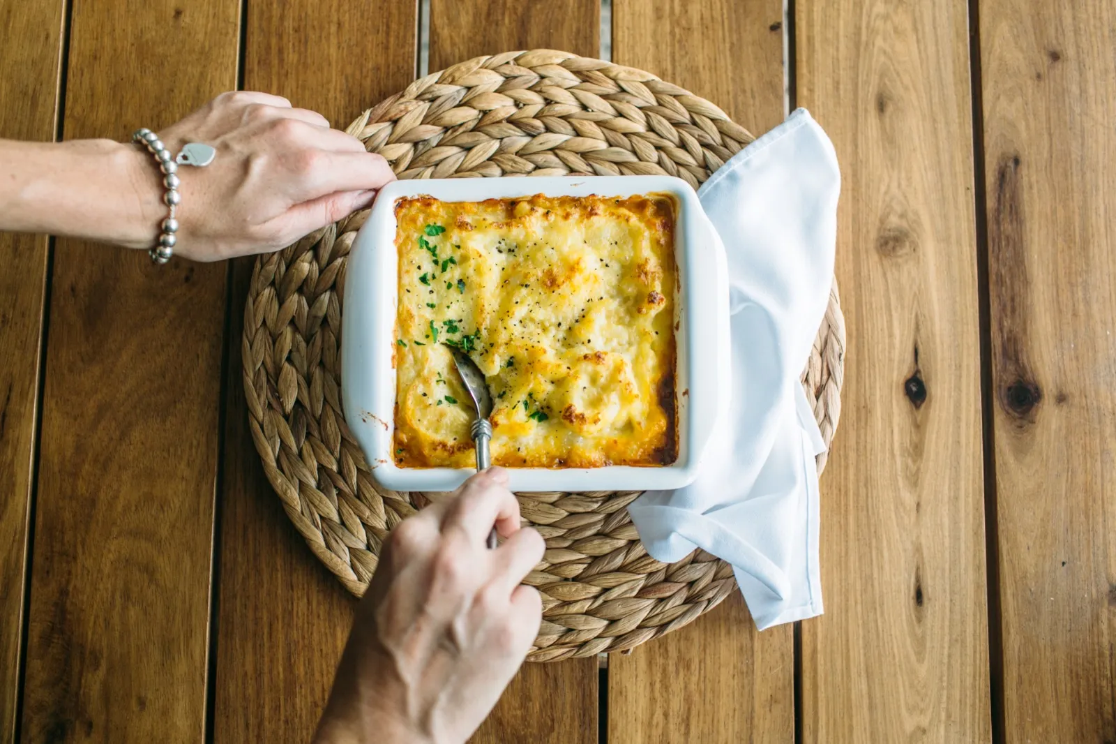 Creamy shepherd's pie being served from a white dish
